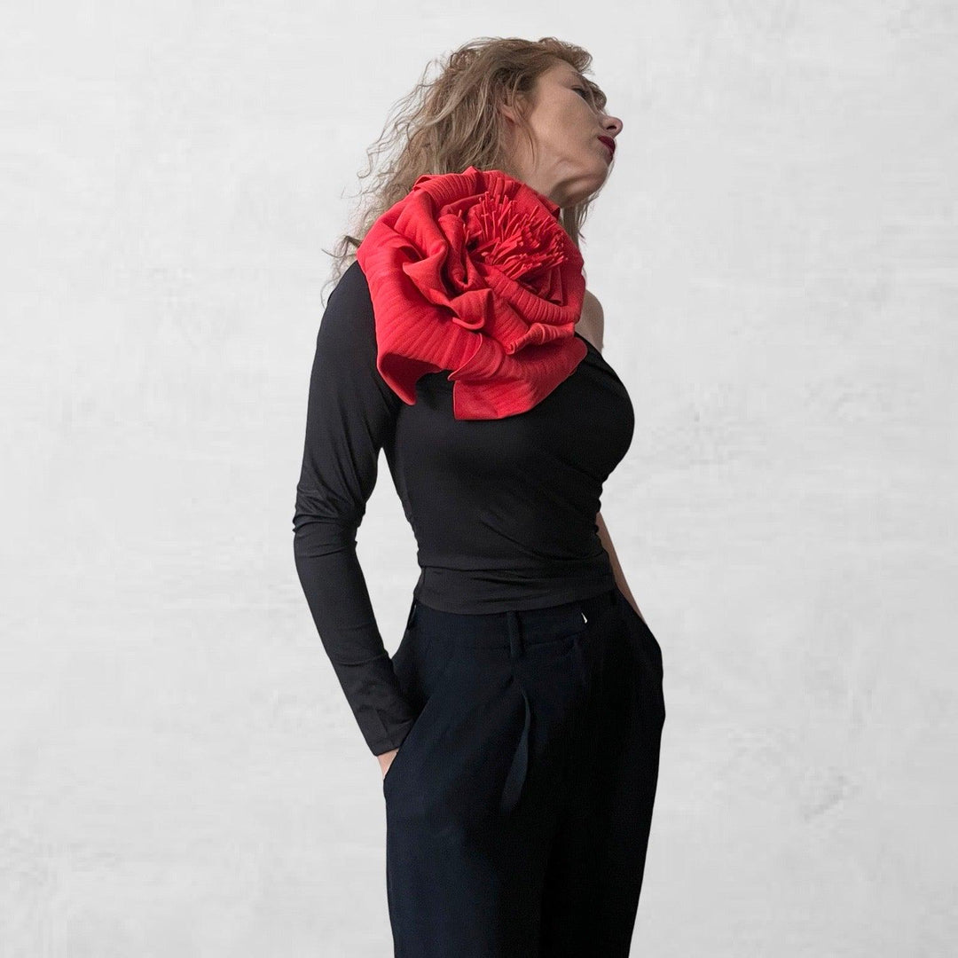 Black one sleeve top with red flower pin