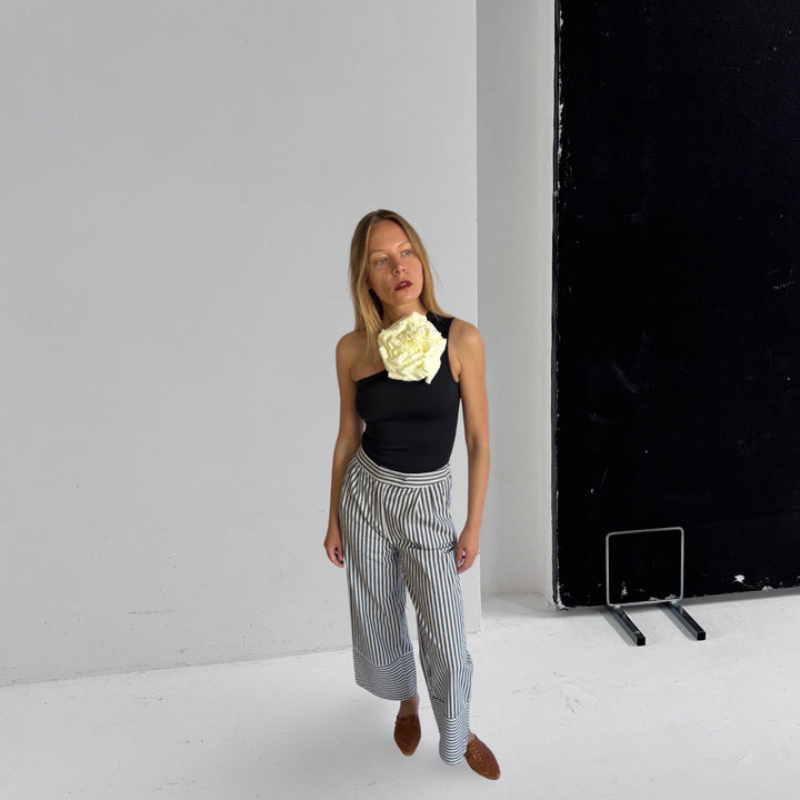 Black One Shoulder Top With White Flower Pin