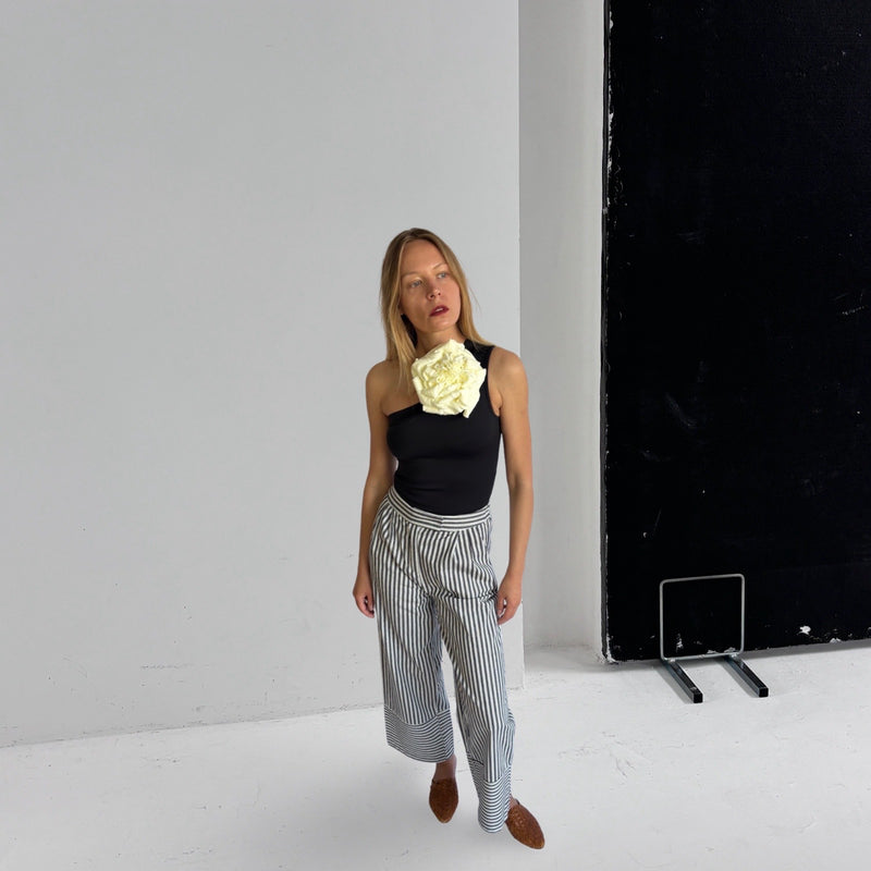 Black One Shoulder Top With White Flower Pin
