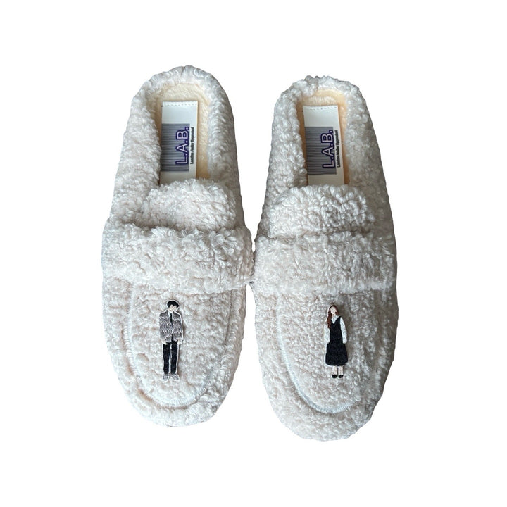 Beige shearling mules with embroidery patches
