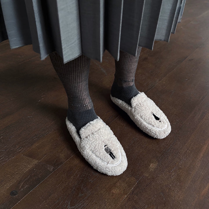 Beige shearling mules with embroidery patches