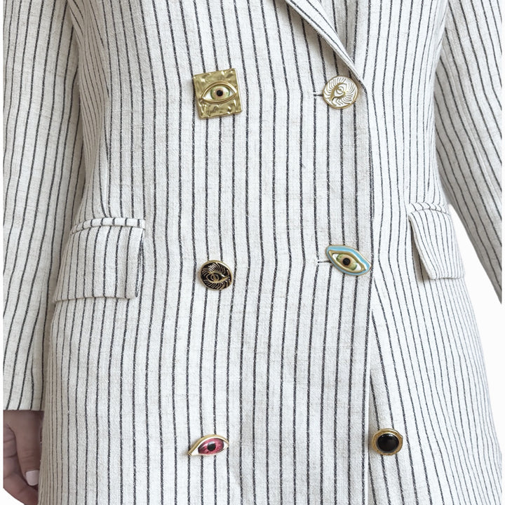 Ivory pin stripe linen double breasted suit with surrealist eye buttons