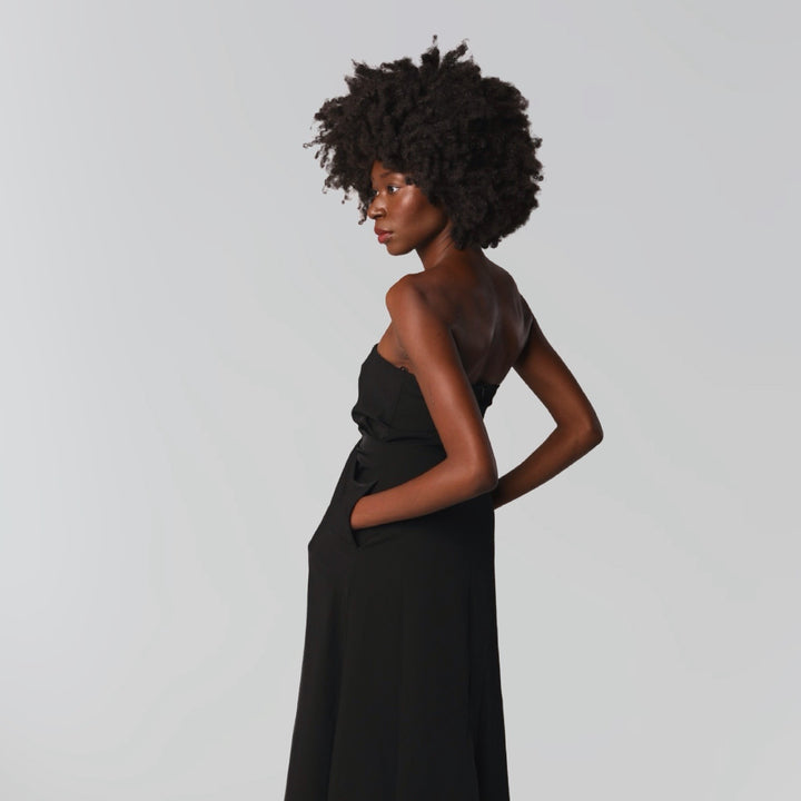 Black strapless dress with asymmetrical folds and pearl detail