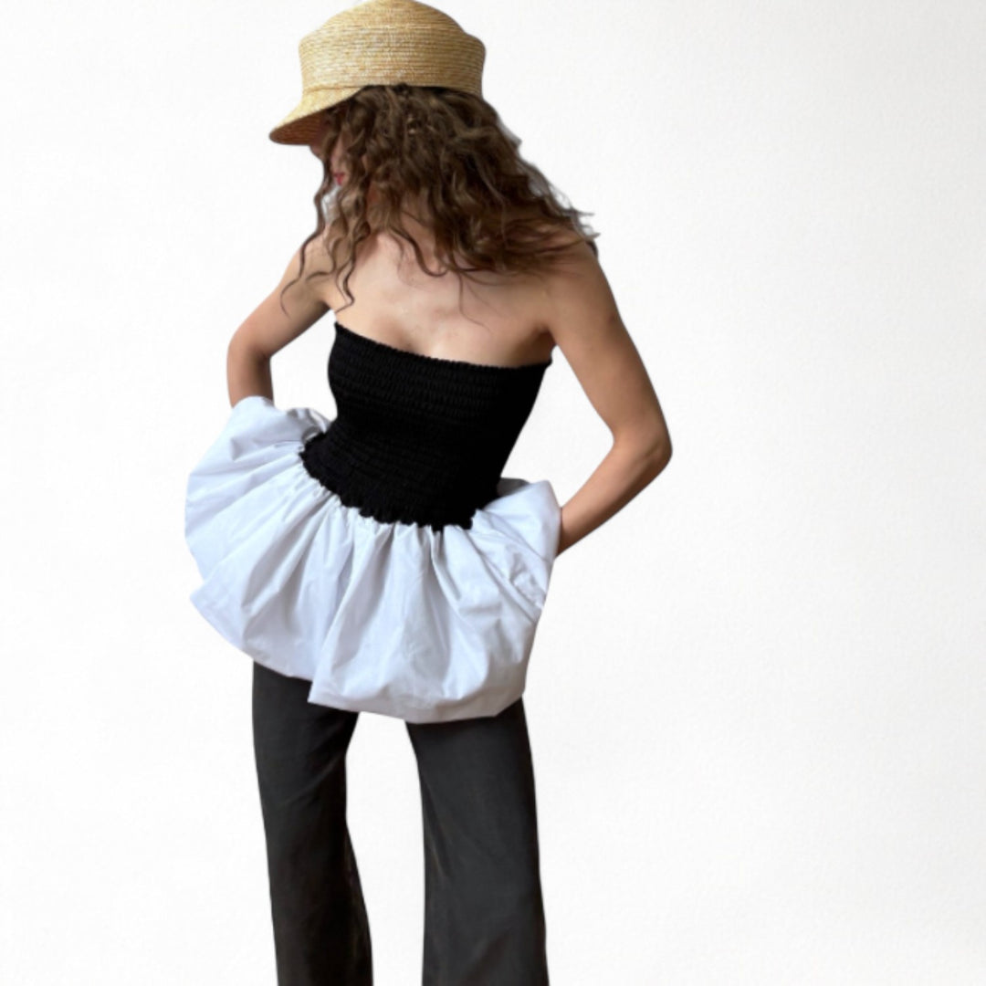 Black smocked top with white balloon peplum