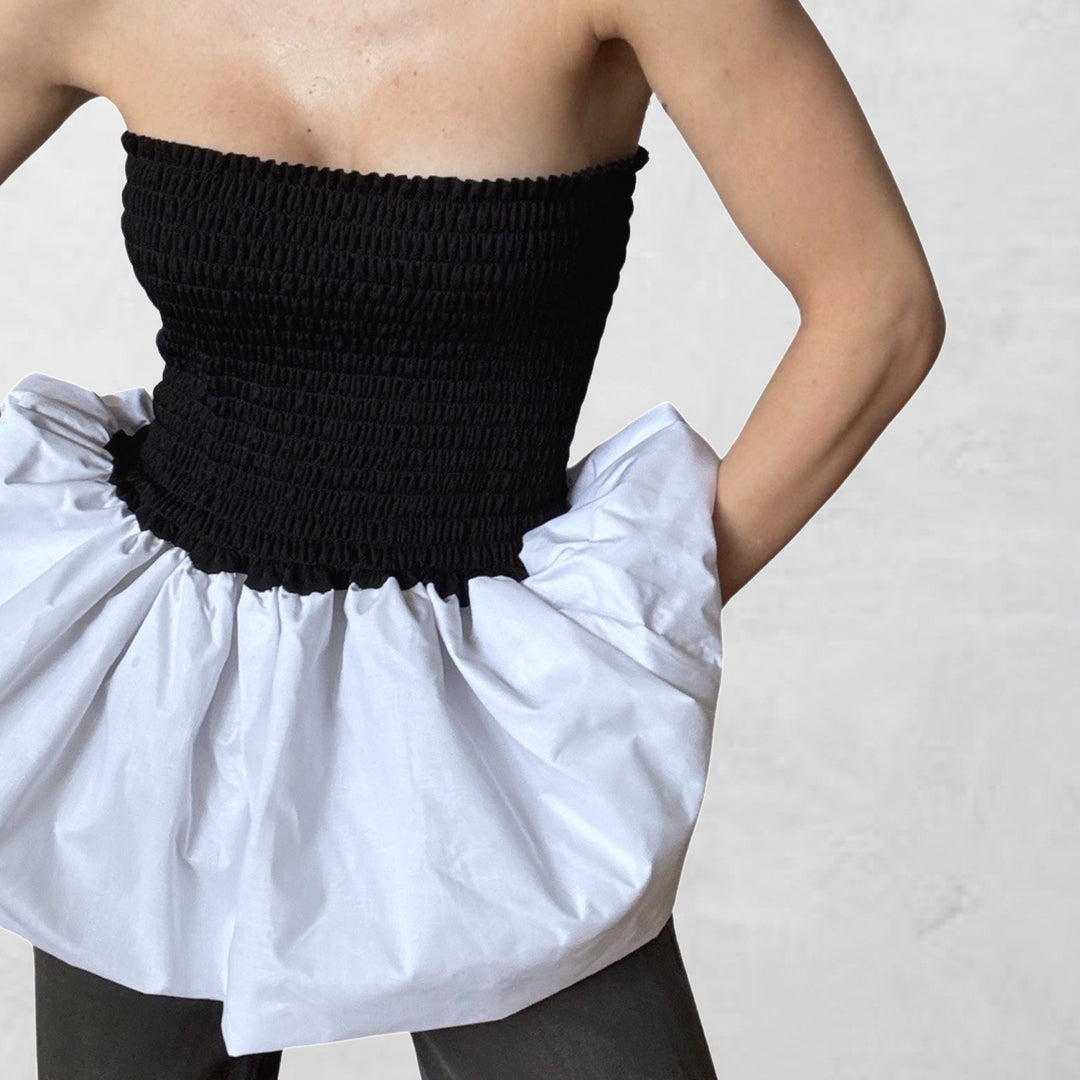 Black smocked top with white balloon peplum