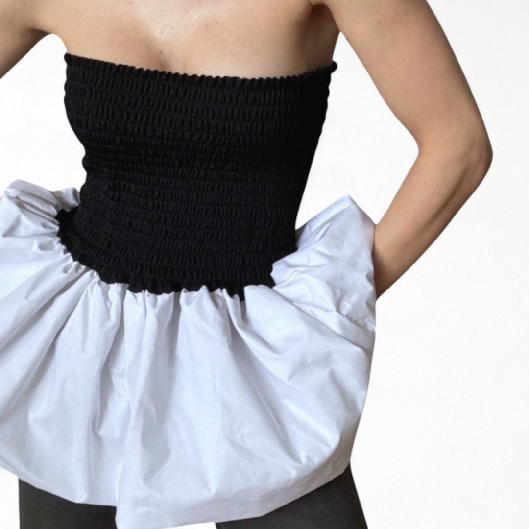 Black smocked top with white balloon peplum