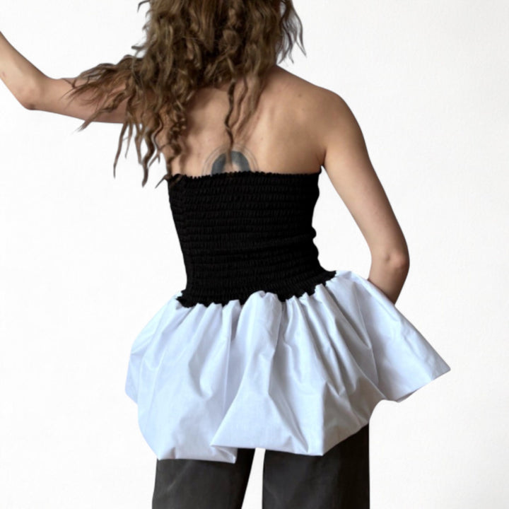 Black smocked top with white balloon peplum