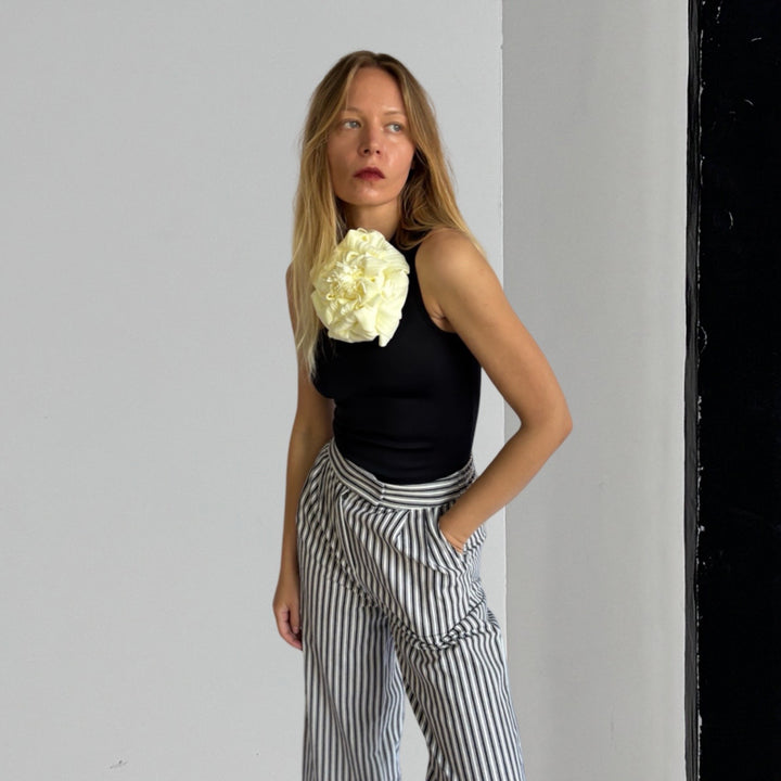 Black One Shoulder Top With White Flower Pin