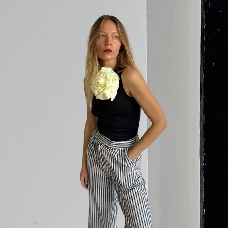 Black One Shoulder Top With White Flower Pin
