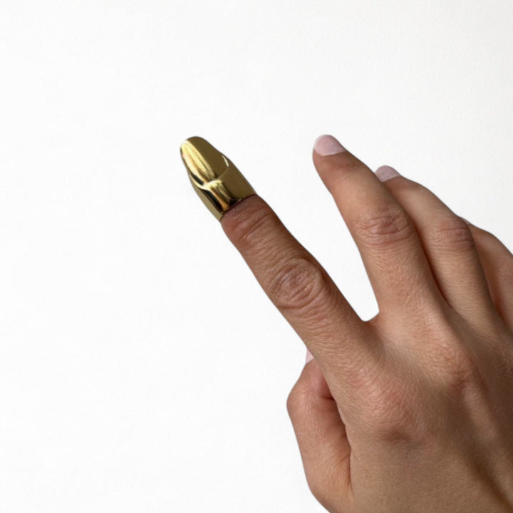 Gold finger cover with nail detail