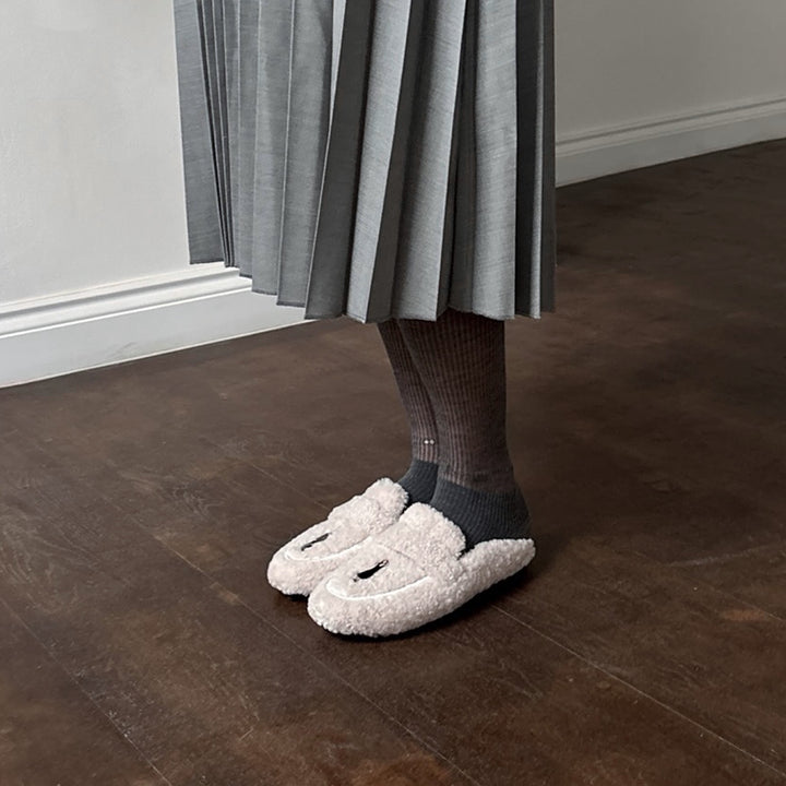 Beige shearling mules with embroidery patches