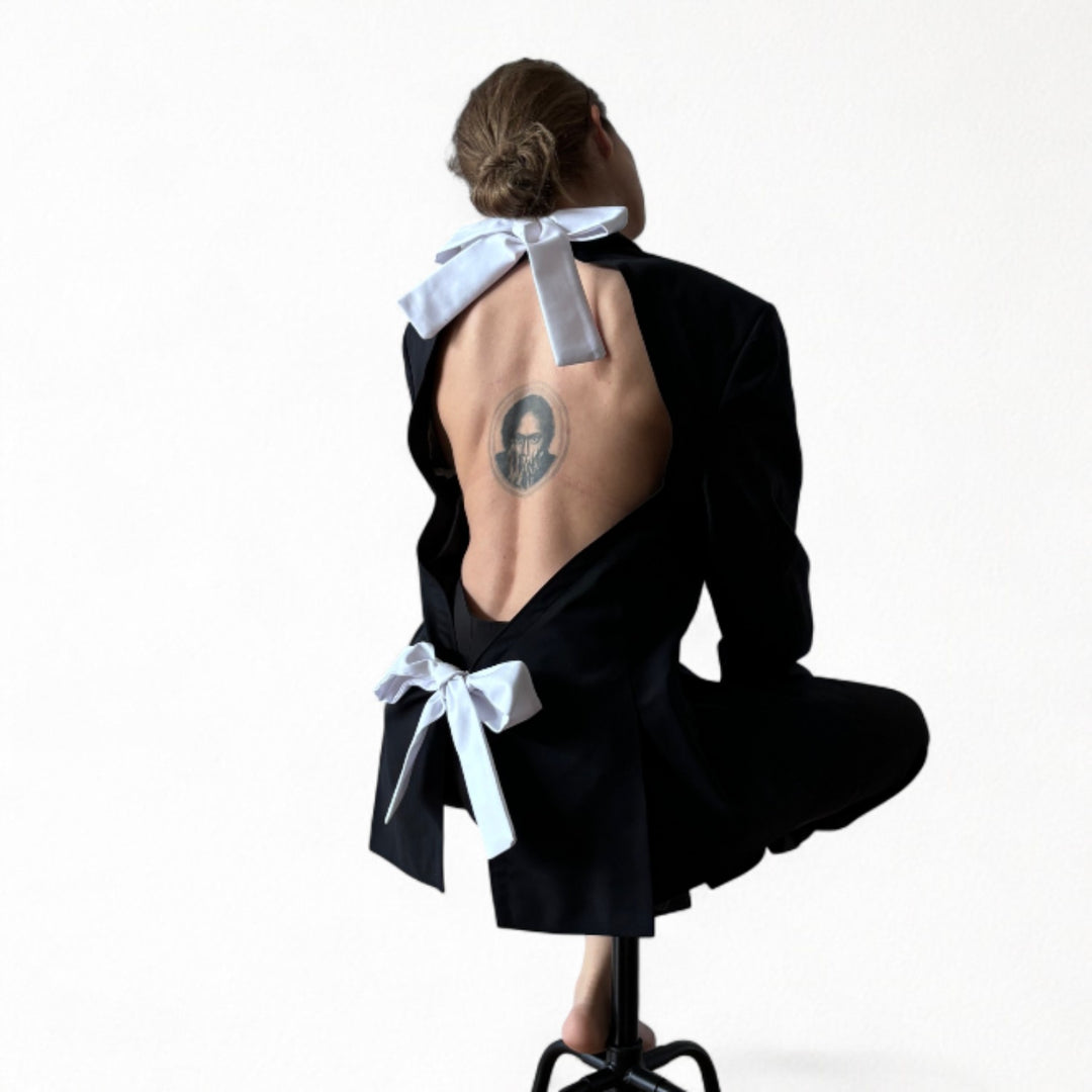 Reworked black blazer with open back and white bows