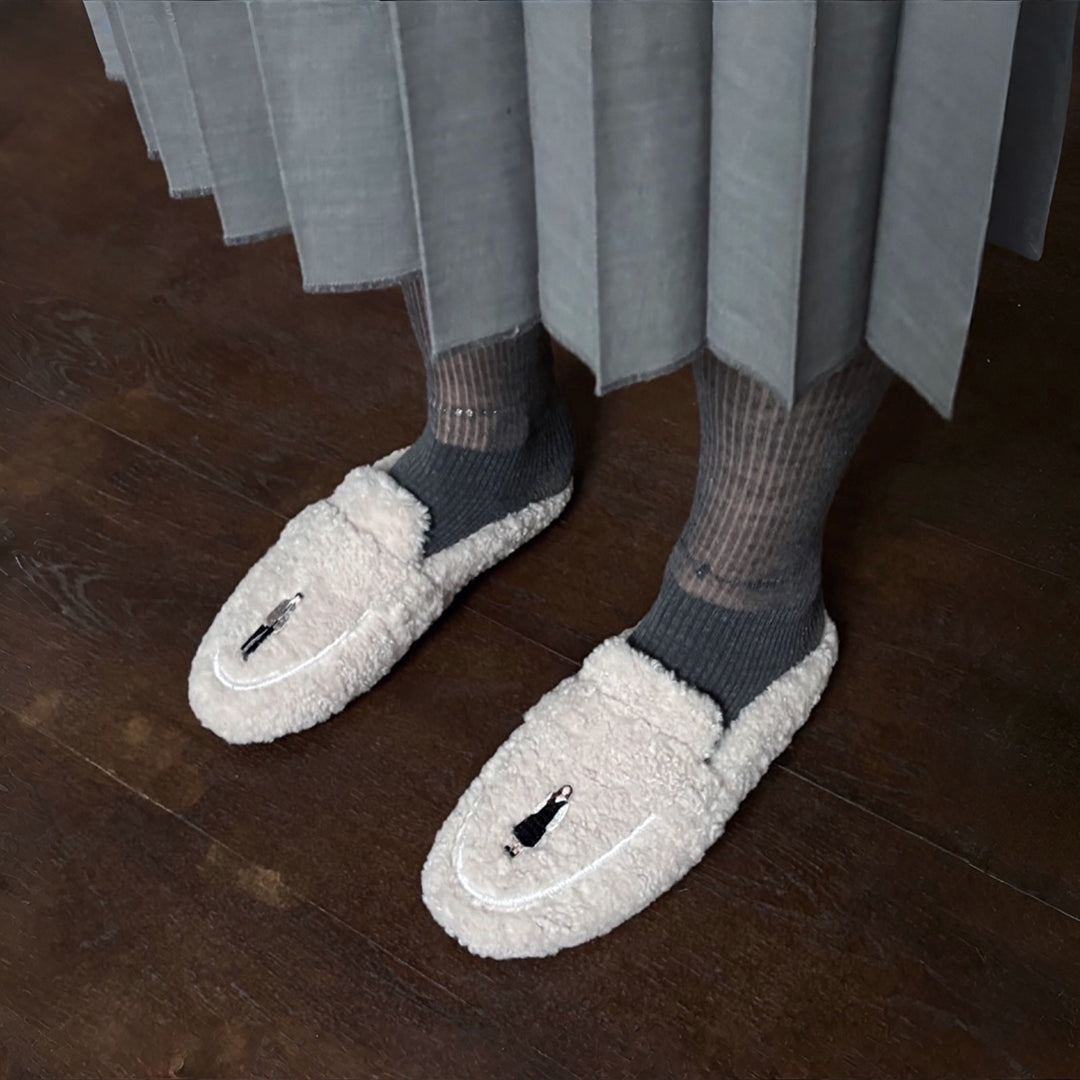 Beige shearling mules with embroidery patches