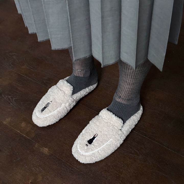 Beige shearling mules with embroidery patches