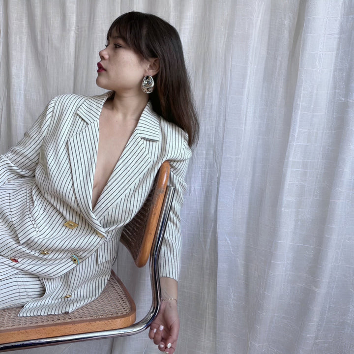 Ivory pin stripe linen double breasted suit with surrealist eye buttons