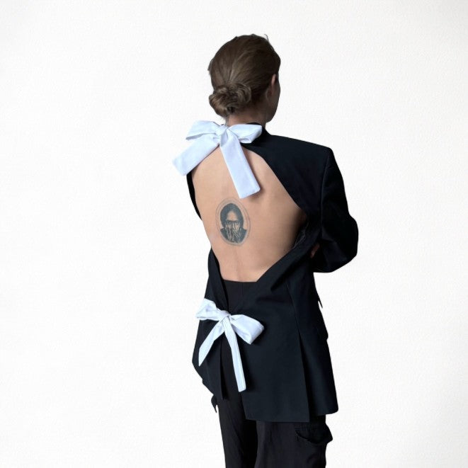 Reworked black blazer with open back and white bows