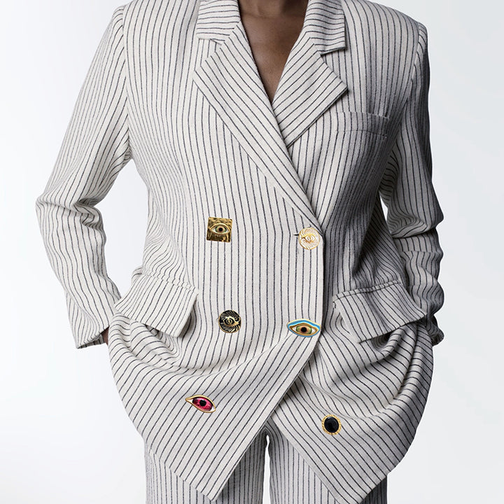 Ivory pin stripe linen double breasted suit with surrealist eye buttons