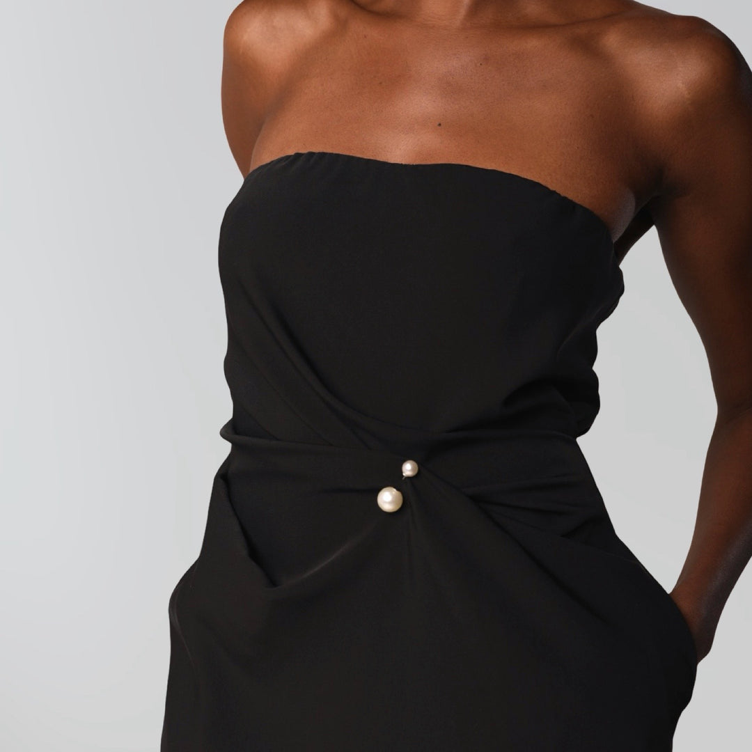 Black strapless dress with asymmetrical folds and pearl detail