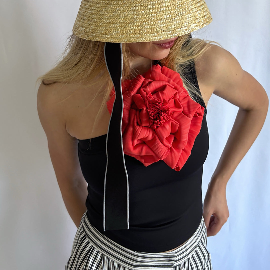 Black one shoulder top with red flower pin