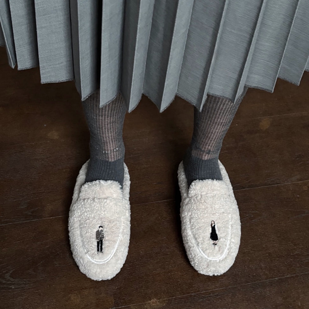 Beige shearling mules with embroidery patches