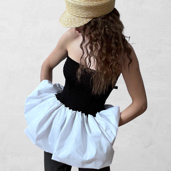 Black smocked top with white balloon peplum