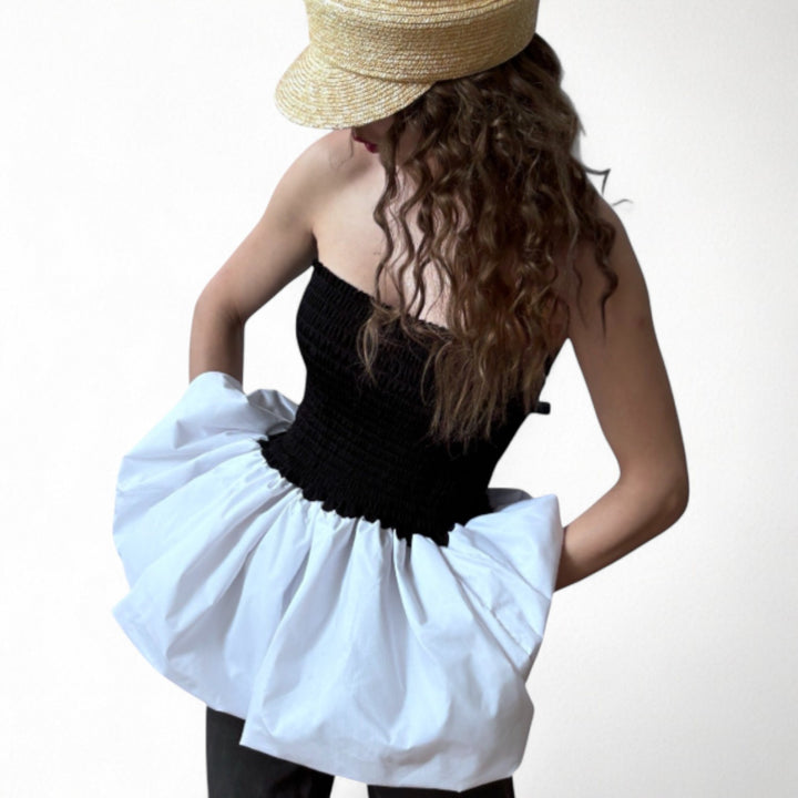 Black smocked top with white balloon peplum