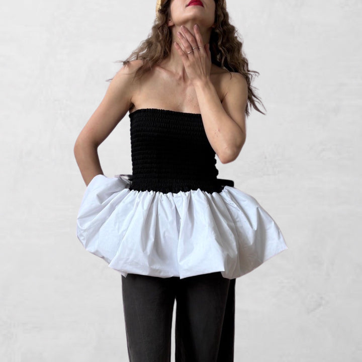 Black smocked top with white balloon peplum