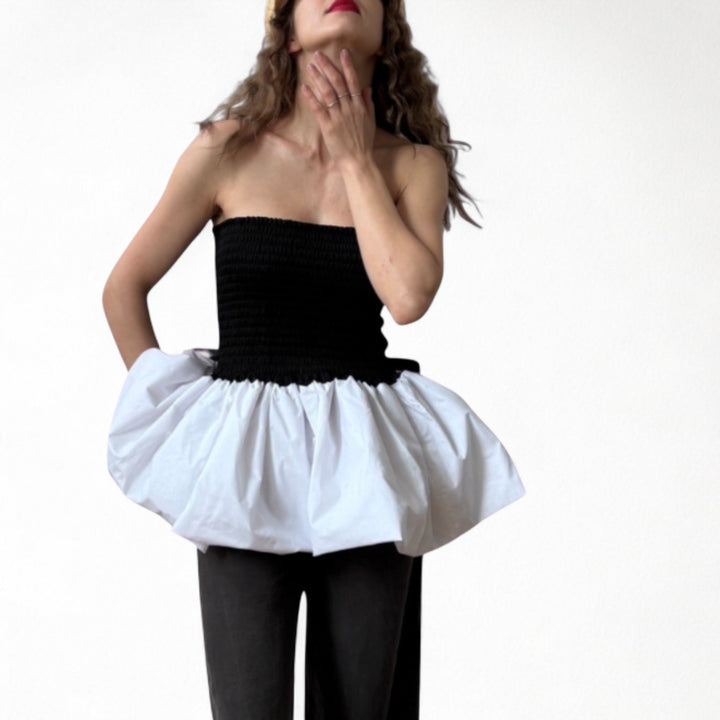 Black smocked top with white balloon peplum