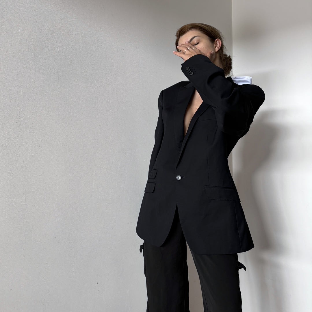 Reworked black blazer with open back and white bows