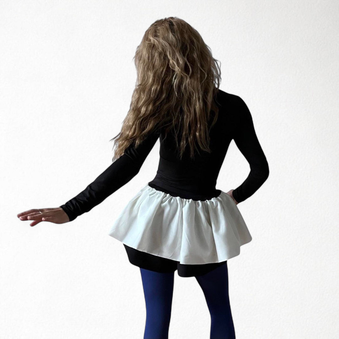 Black top with white balloon ruffle peplum