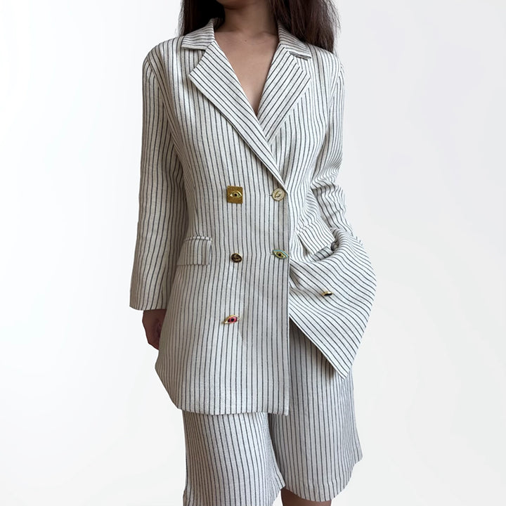 Ivory pin stripe linen double breasted suit with surrealist eye buttons