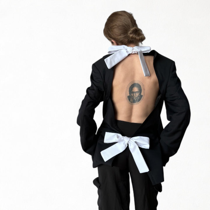 Reworked black blazer with open back and white bows