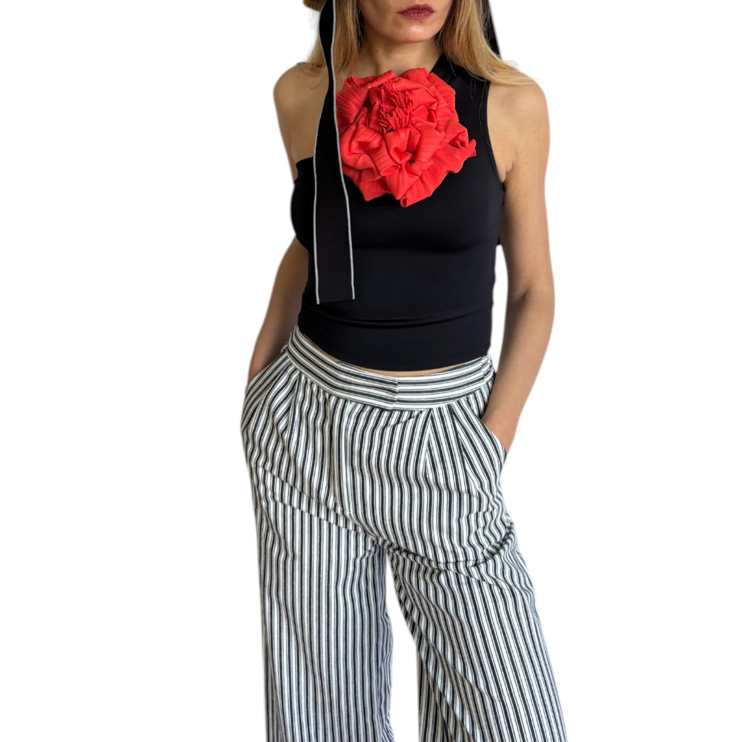 Black one shoulder top with red flower pin