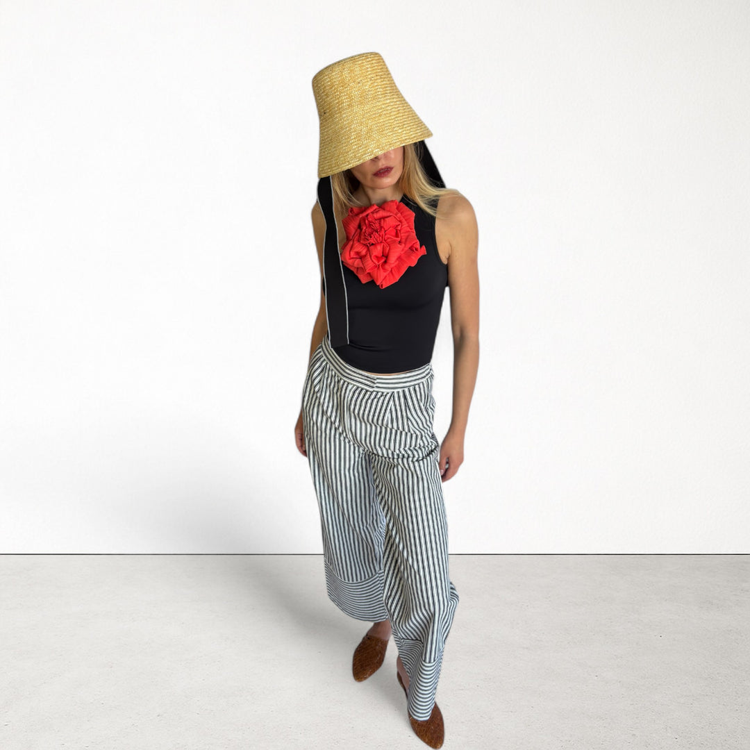 Black one shoulder top with red flower pin