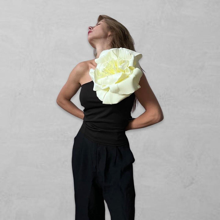 Black one shoulder top with white flower pin