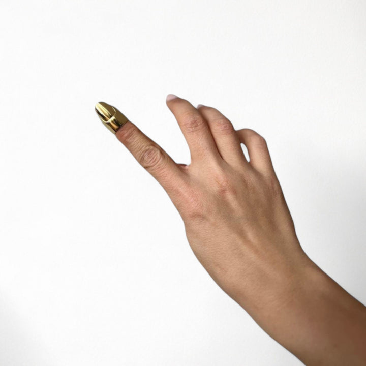 Gold finger cover with nail detail
