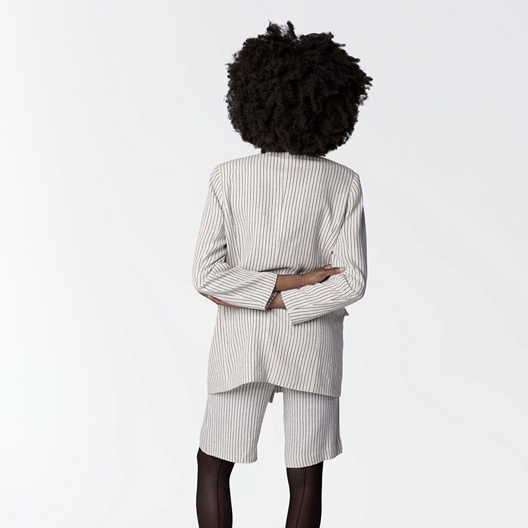 Ivory pin stripe linen double breasted suit with surrealist eye buttons