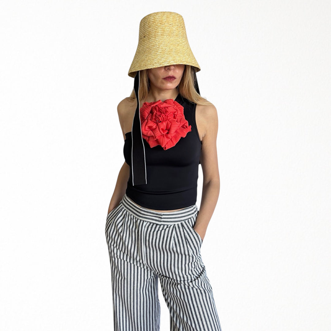 Black one shoulder top with red flower pin
