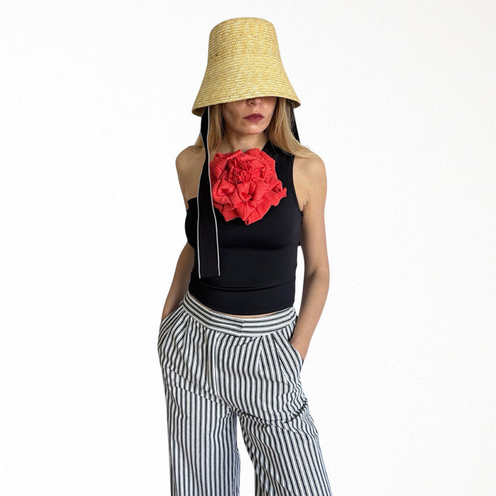 Black one shoulder top with red flower pin