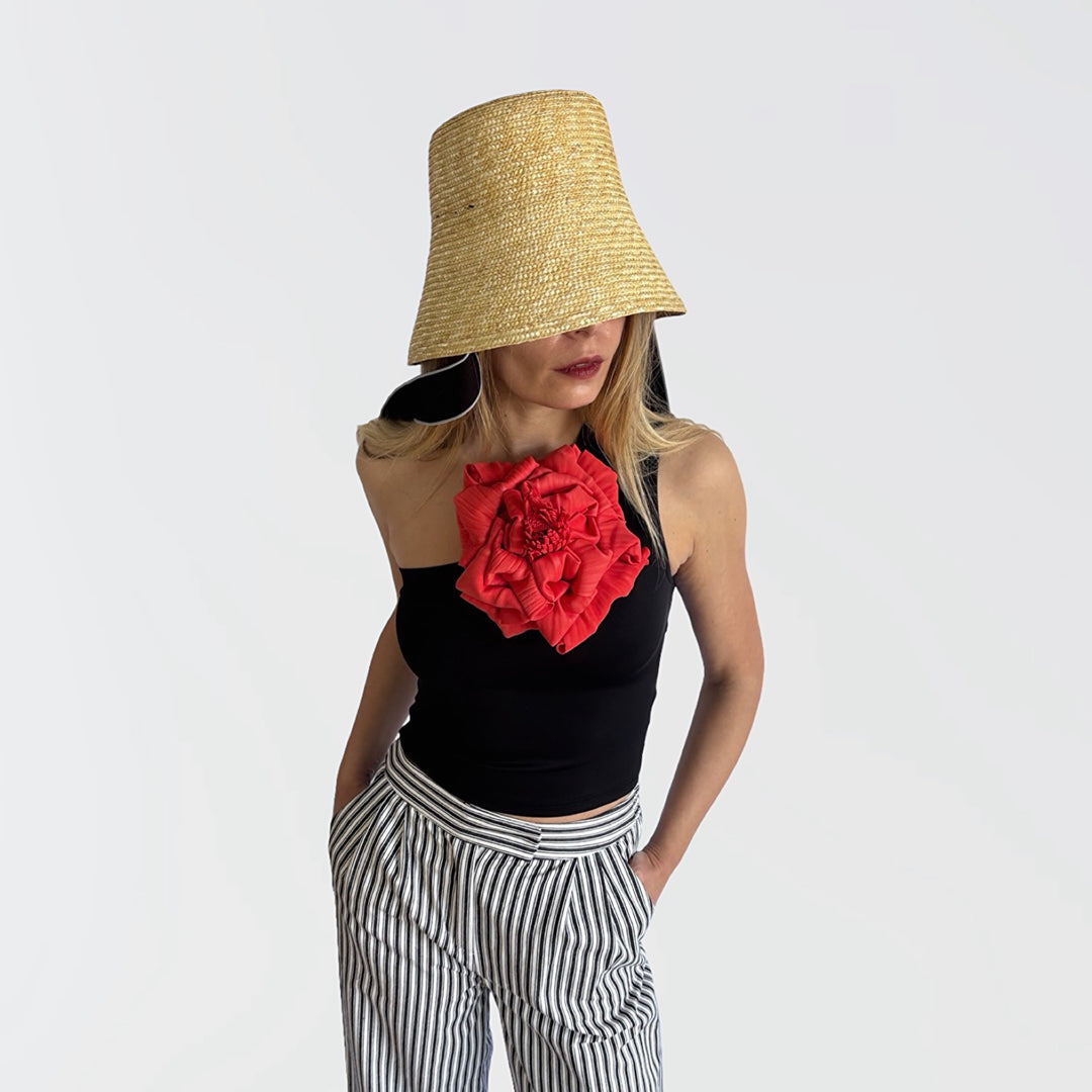 Black one shoulder top with red flower pin