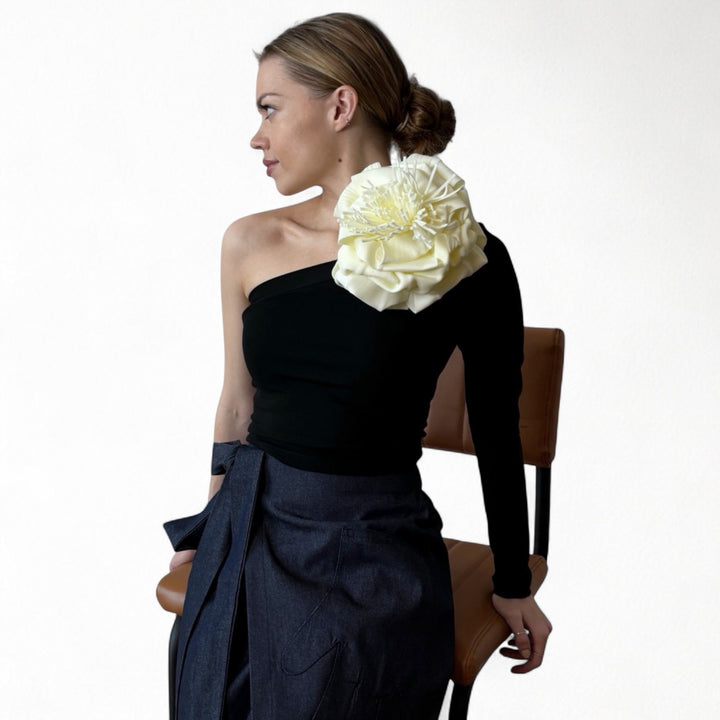 Black one sleeve top with white flower pin