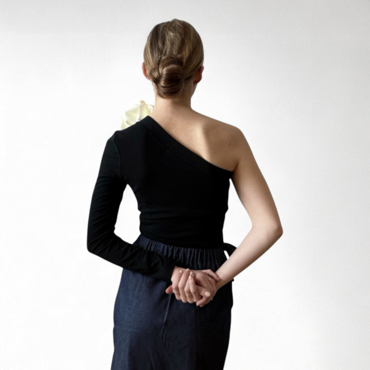 Black one sleeve top with white flower pin