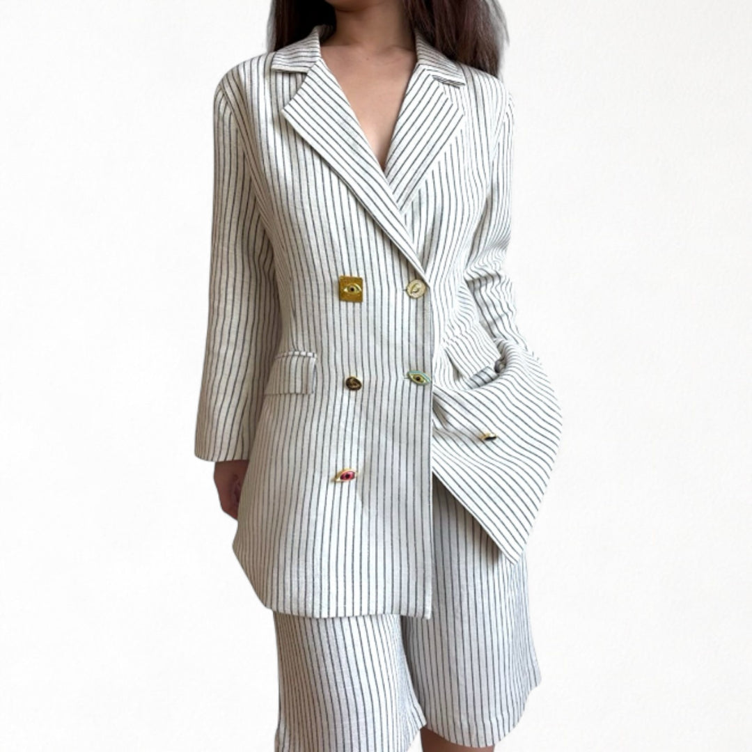 Ivory pin stripe linen double breasted suit with surrealist eye buttons