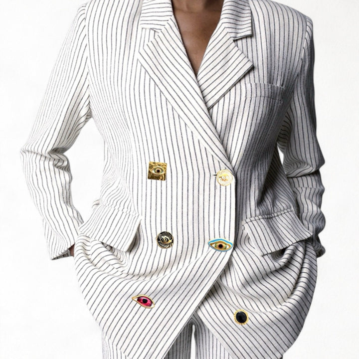 Ivory pin stripe linen double breasted suit with surrealist eye buttons