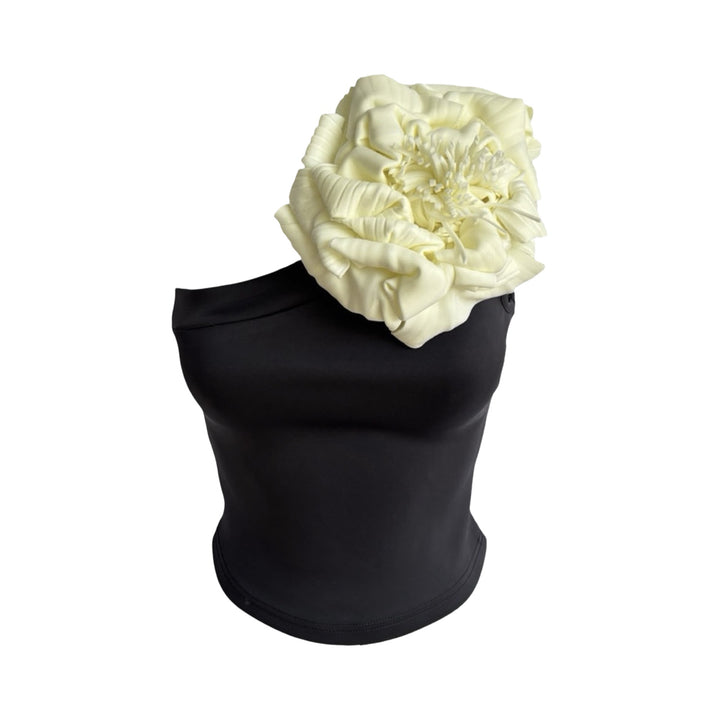 Black one shoulder top with white flower pin