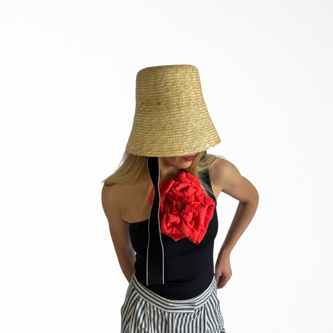 Black one shoulder top with red flower pin
