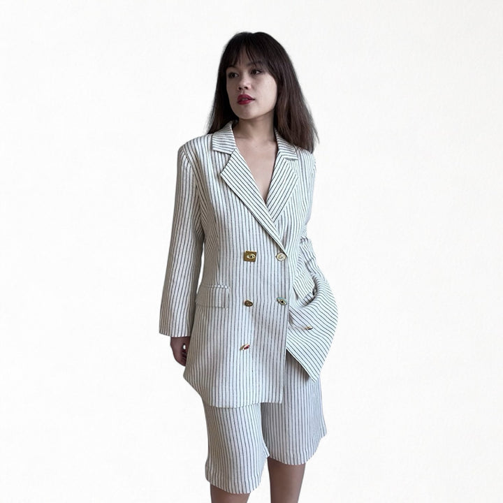 Ivory pin stripe linen double breasted suit with surrealist eye buttons