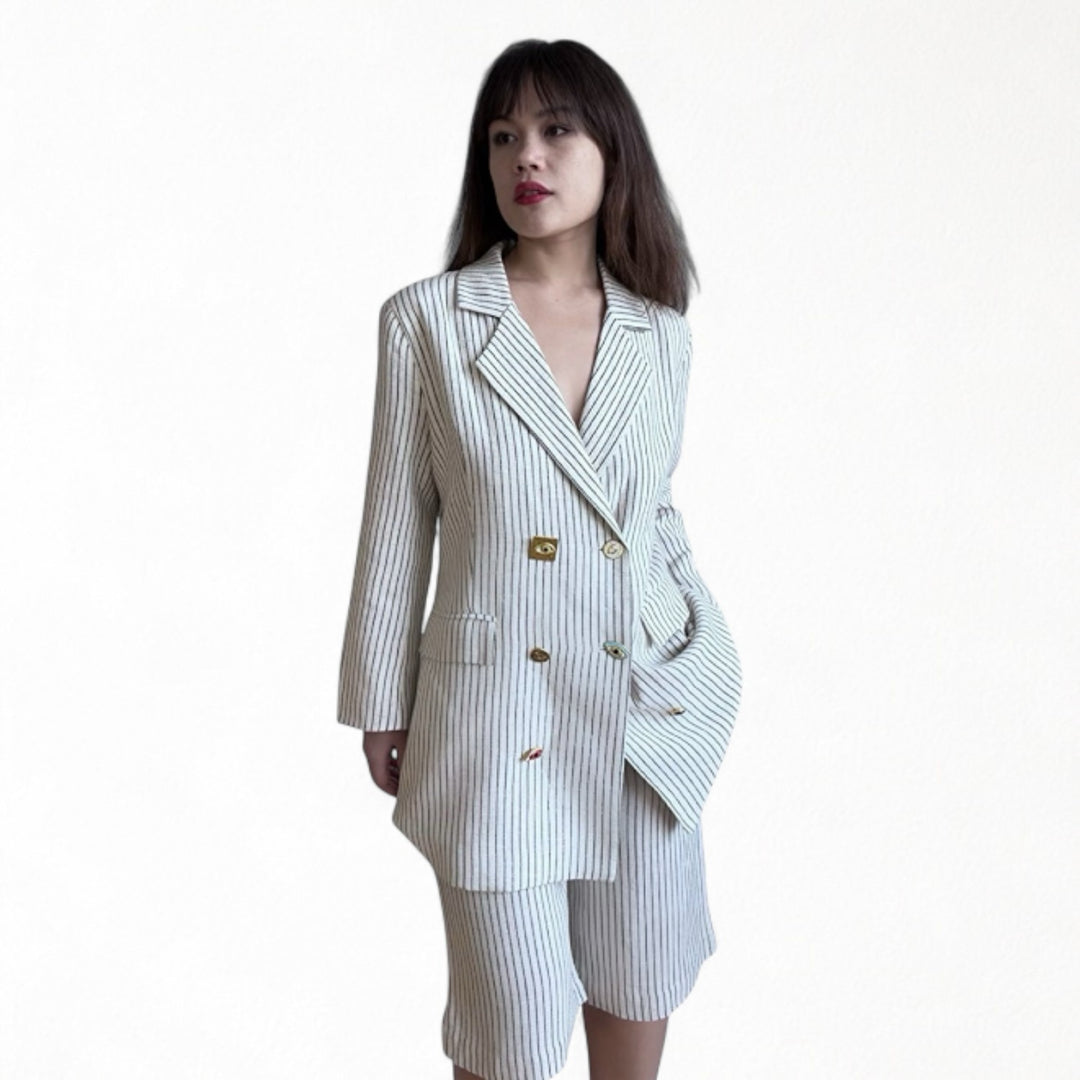 Ivory pin stripe linen double breasted suit with surrealist eye buttons