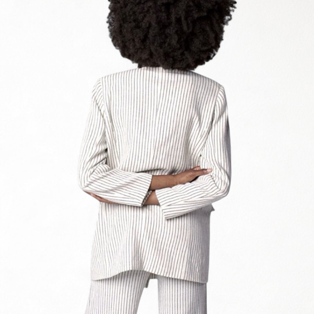 Ivory pin stripe linen double breasted suit with surrealist eye buttons