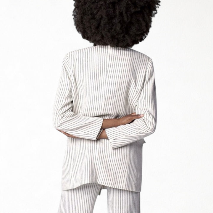Ivory pin stripe linen double breasted suit with surrealist eye buttons